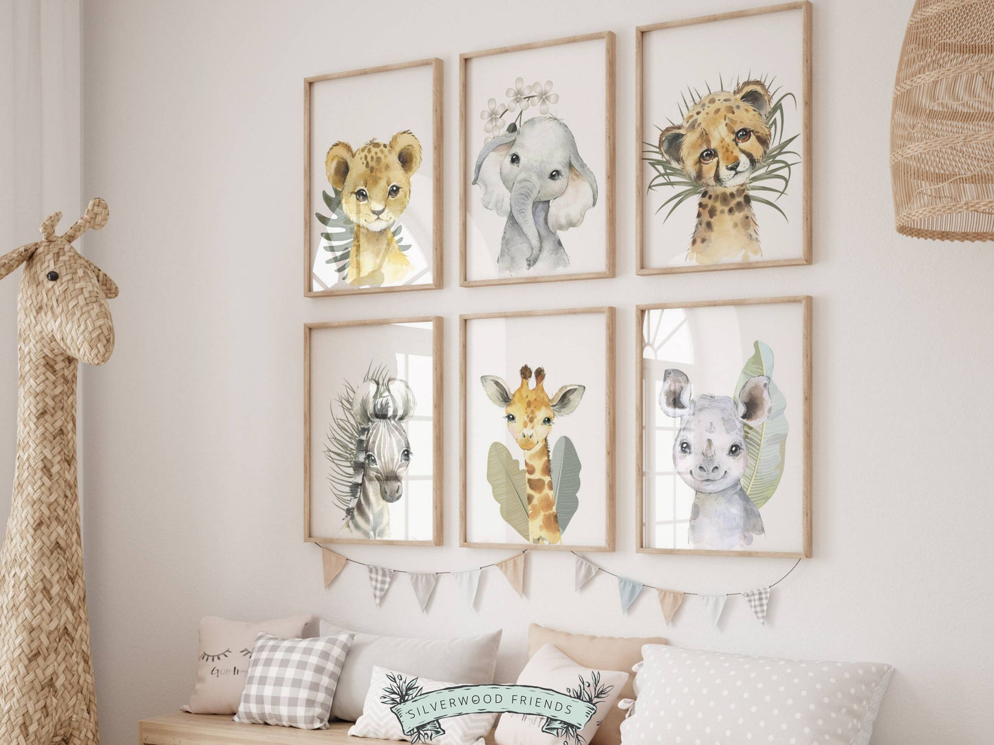 Our Baby Safari Animal Print Set of 6 with baby safari animals lion, elephant, leopard, zebra, giraffe and rhino is set on a white background with tropical jungle leaves and is perfect for your jungle nursery decor or as a safari baby shower gift.