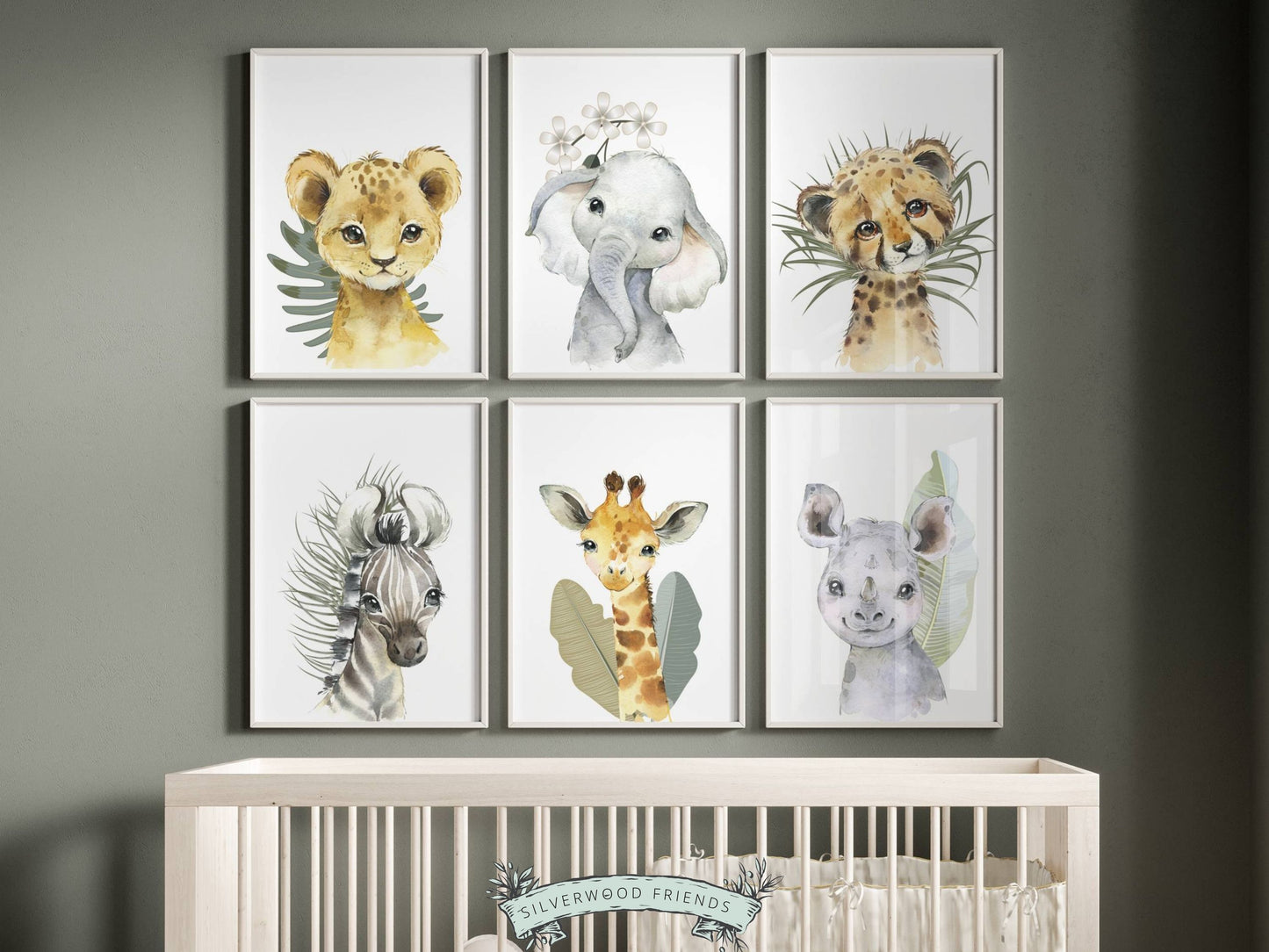 Our Baby Safari Animal Print Set of 6 with baby safari animals lion, elephant, leopard, zebra, giraffe and rhino is set on a white background with tropical jungle leaves and is perfect for your jungle nursery decor or as a safari baby shower gift.