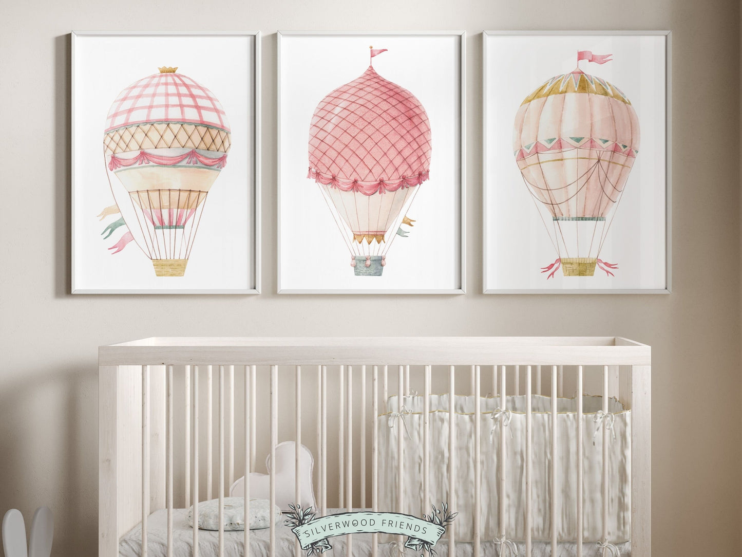 Set of 3 watercolor pink Hot Air Balloon Prints. Whether adorning a nursery or adding a pop of color to a dorm room, these vibrant prints are as playful as they are versatile. Perfect for your nursery decor and as a baby shower gift.