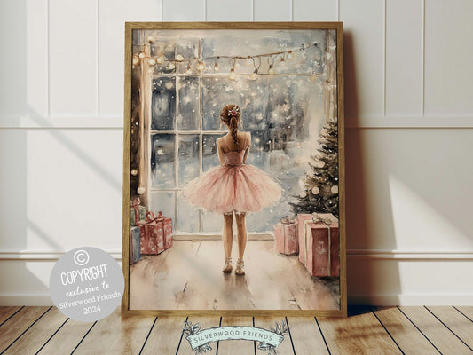 Charming ballerina Christmas print showcases a sweet little ballerina in a pale pink tutu, standing under twinkling fairy lights by a Christmas tree and gazing at the falling snow. The perfect gift for a young ballet lover or a babys first Christmas