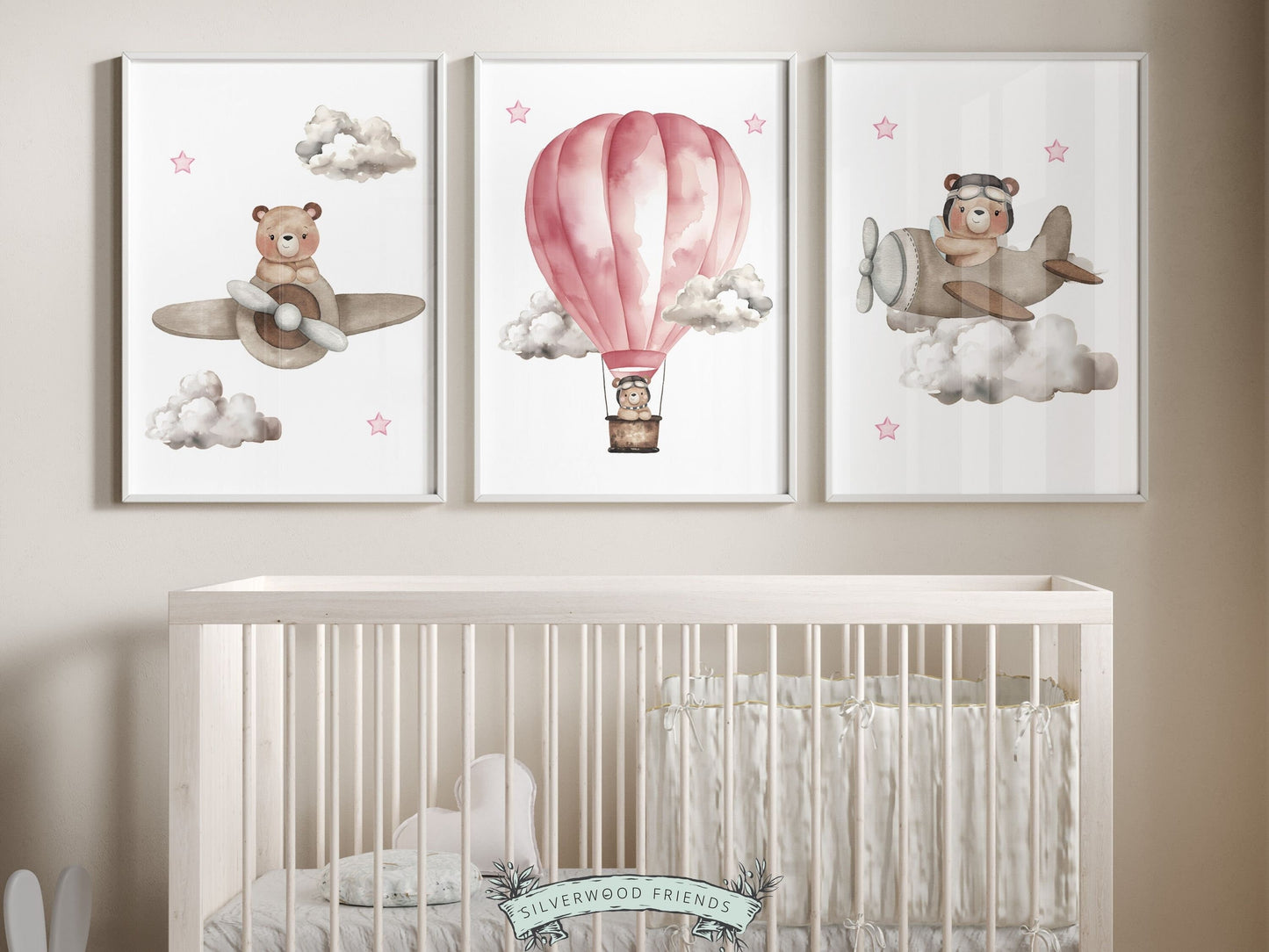 Set of 3 Pink Watercolor Hot Air Balloon Nursery Prints featuring watercolor teddy bears souring through the sky in a pink hot air balloon and beige airplanes. Its perfect for your baby girls nursery decor and as an adorable baby shower gift.