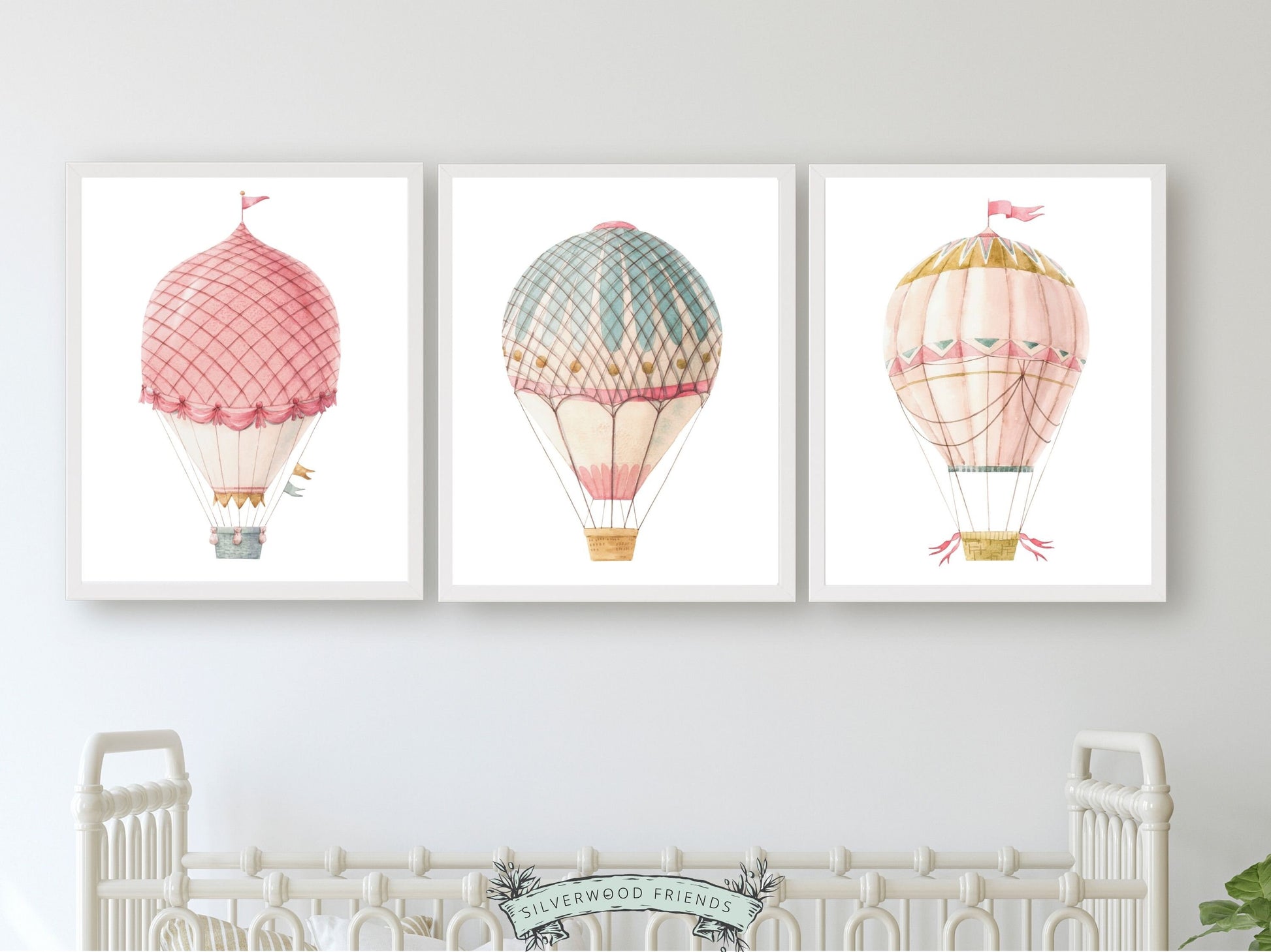 set of 3 watercolour pink and blue Hot Air Balloon Prints. Whether adorning a nursery or adding a pop of colour to a dorm room, these vibrant prints are as playful as they are versatile, making them an ideal choice for both personal decor and thoughtful gifts for any occasion.