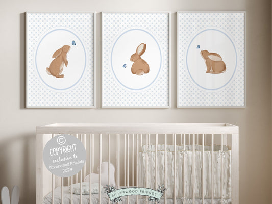 Our gorgeous Bunny Nursery Print Set of 3, showcasing adorable bunny rabbits and blue butterflies with baby blue wallpaper pattern, is perfect for your woodland nursery decor and makes a unique baby shower gift for both boys and girls.