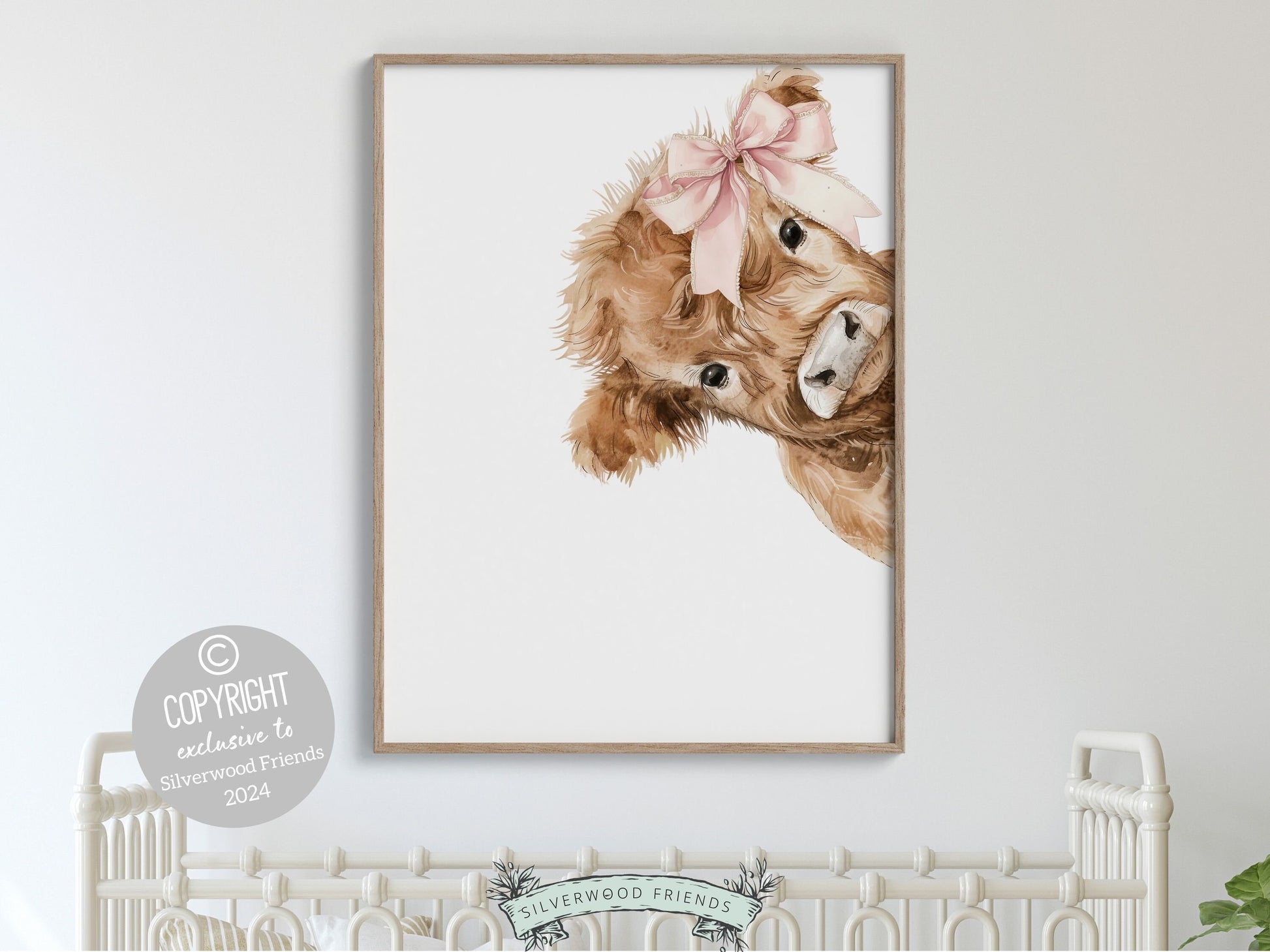 Our Peeking Highland Cow Nursery Print featuring adorable watercolor peeking baby highland cow with pink bow, is set on a white background and is perfect for your baby girls farm nursery decor or as a unique farm baby shower gift.