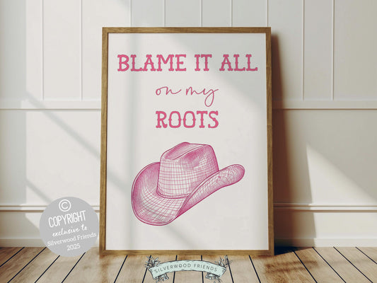 Pink Cowgirl Print, featuring a cowgirl hat and quote Blame it all on my roots. Perfect for country themed decor, this stylish artwork makes a lovely addition to a nursery, teen room, or any cowgirl inspired space!
