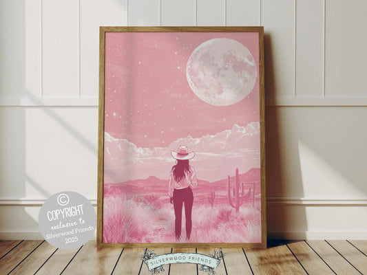 Cowgirl print, featuring a lone cowgirl gazing across the desert beneath a full moon and star studded sky. Designed in rich black and pink tones, this artwork is perfect for a southwestern nursery, dorm room, or as a gift for any cowgirl at heart!