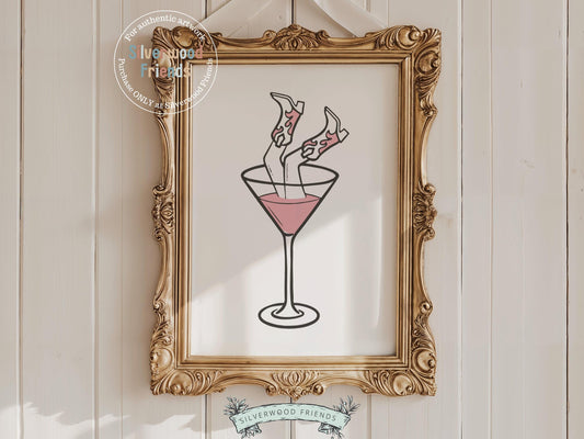 Add a splash of western flair to your space with our Cowgirl Print, featuring a chic line drawing of cowgirl boots playfully perched upside down in a martini glass. Perfect for country-themed decor, this fun and sassy artwork brings a bold touch to any cowgirl-inspired room or gallery wall.