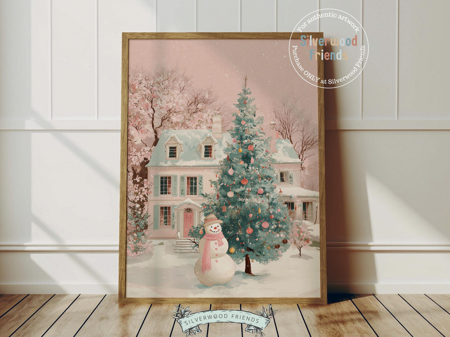 This delightful Christmas print features a cheerful snowman in a soft pink scarf standing before a pastel pink and green village house dusted with snow. With its gentle watercolor tones and whimsical charm, it brings a cozy, festive touch to any nursery or holiday home décor.