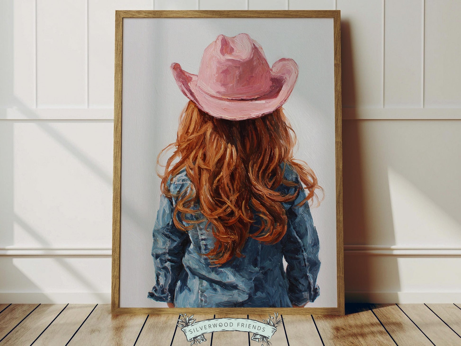 Create a calm and beautiful space with this western cowgirl wall art print, featuring a softly styled portrait of a young red-haired cowgirl in a pink cowgirl hat, illustrated in a dreamy oil painting style with visible brushstroke texture and warm, rustic tones. This timeless artwork has a rich, canvas-like finish that adds depth, softness, and a charming farmhouse feel to any room.