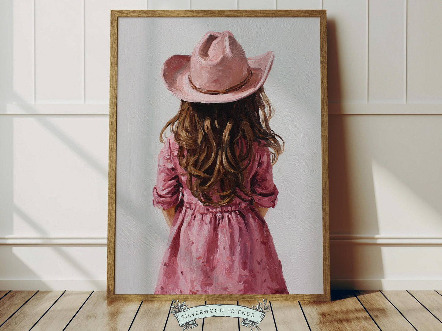 Create a calm and beautiful space with this western cowgirl wall art print, featuring a softly styled portrait of a young brown-haired cowgirl in a pink cowgirl hat and dress, illustrated in a dreamy oil painting style with visible brushstroke texture and warm, rustic tones. This timeless artwork has a rich, canvas-like finish that adds depth, softness, and a charming farmhouse feel to any room.