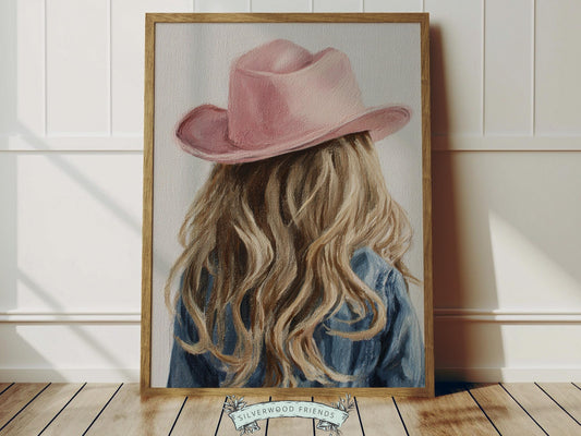 Create a calm and beautiful space with this western cowgirl wall art print, featuring a softly styled portrait of a young cowgirl in a pink cowgirl hat, illustrated in a dreamy oil painting style with visible brushstroke texture and warm, rustic tones. This timeless artwork has a rich, canvas-like finish that adds depth, softness, and a charming farmhouse feel to any room.