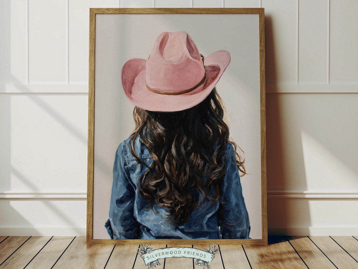 Create a calm and beautiful space with this western cowgirl wall art print, featuring a softly styled portrait of a young brown-haired cowgirl in a pink cowgirl hat, illustrated in a dreamy oil painting style with visible brushstroke texture and warm, rustic tones. This timeless artwork has a rich, canvas-like finish that adds depth, softness, and a charming farmhouse feel to any room.