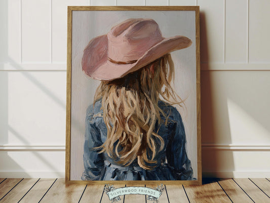Create a calm and beautiful space with this western cowgirl wall art print, featuring a softly styled portrait of a young blonde cowgirl in a pink cowgirl hat, illustrated in a dreamy oil painting style with visible brushstroke texture and warm, rustic tones. This timeless artwork has a rich, canvas-like finish that adds depth, softness, and a charming farmhouse feel to any room.