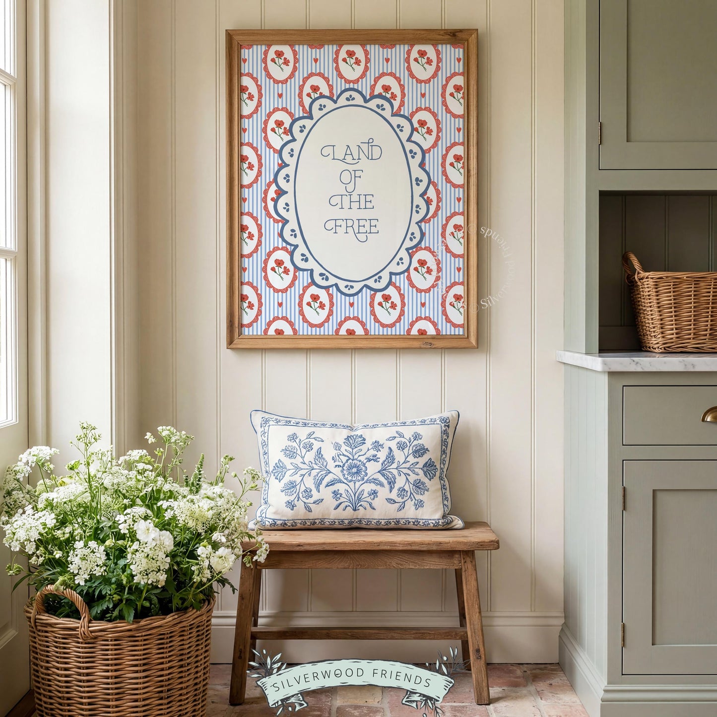 Fourth of July wall art featuring hand-illustrated lettering surrounded by cameo-style red flower medallions and navy accents
