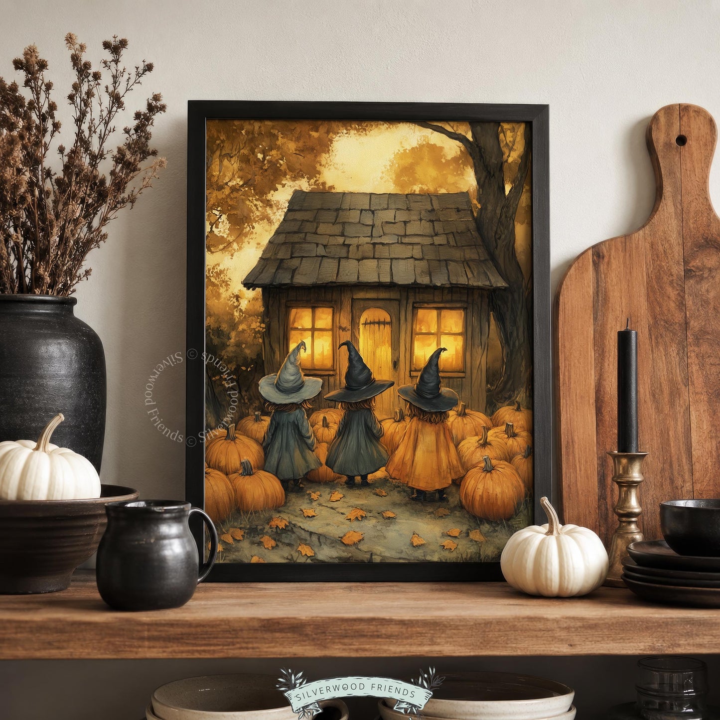 Spooky season picture for entryway — three cloaked figures approaching candlelit house with warm harvest colors