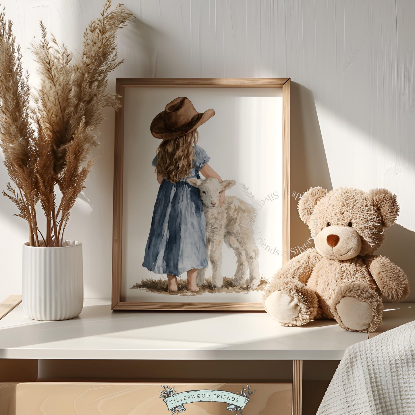 Little one embracing lamb wall art for toddler room — loose brushwork farmland scene in warm neutrals