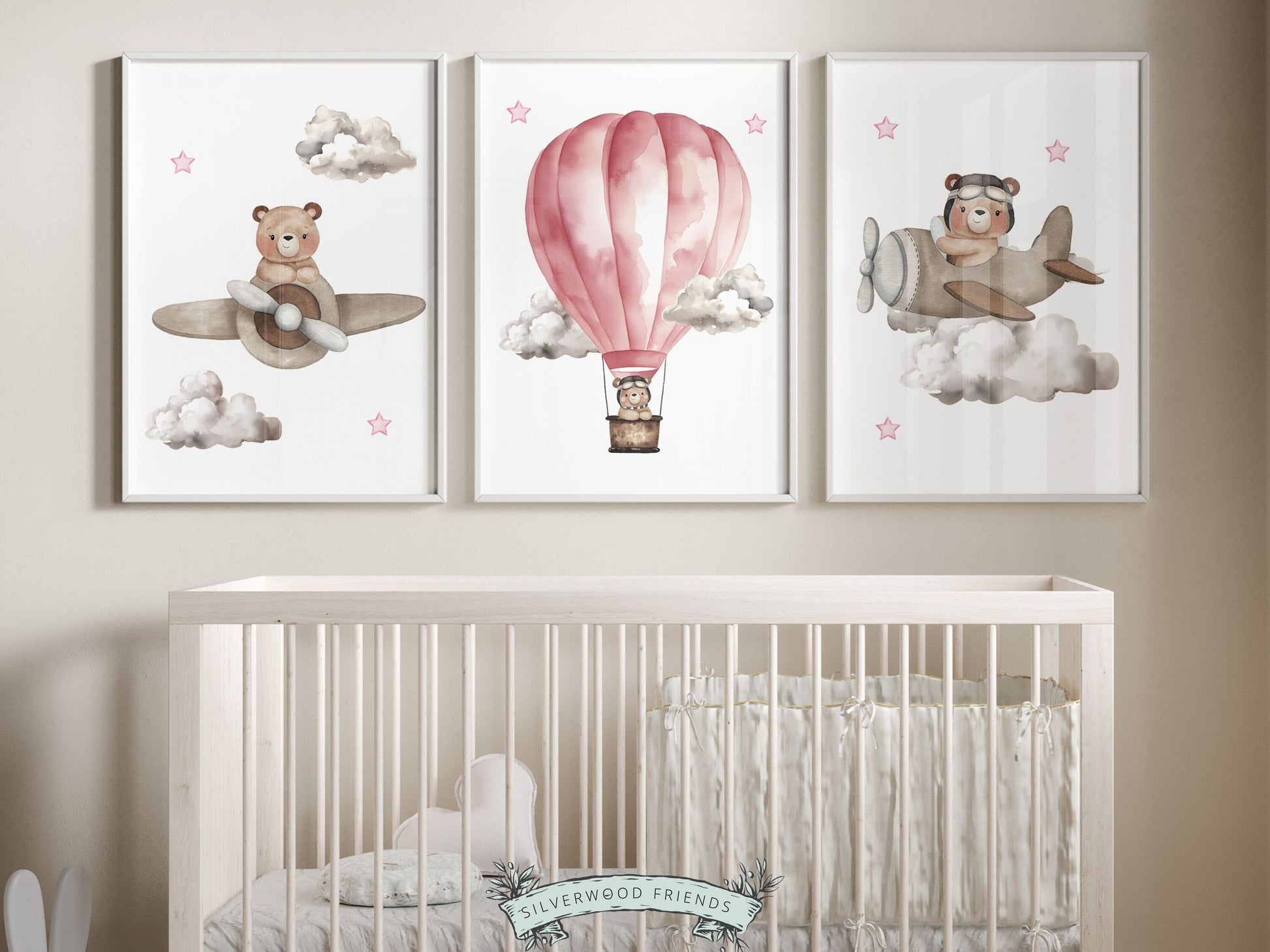 Set of 3 Pink Watercolor Hot Air Balloon Nursery Prints featuring watercolor teddy bears souring through the sky in a pink hot air balloon and beige airplanes. Its perfect for your baby girls nursery decor and as an adorable baby shower gift.