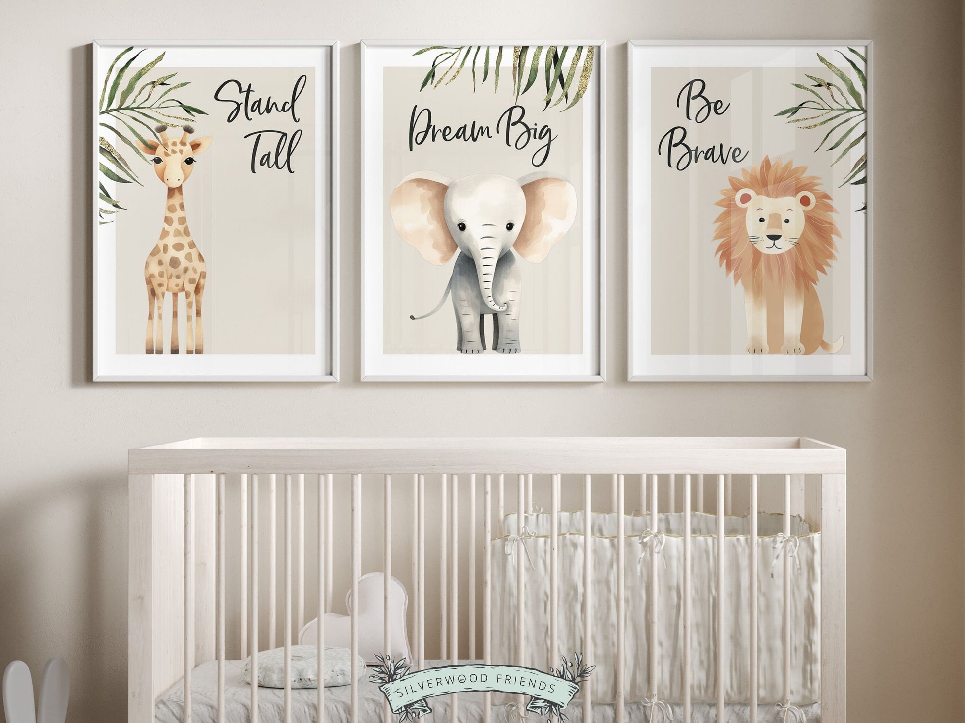 Our Safari Jungle Animal Nursery Prints featuring adorable watercolor illustrations of a giraffe, elephant and lion with jungle leaves and inspirational quotes stand tall, dream big, be brave, is the perfect addition for your safari nursery decor.