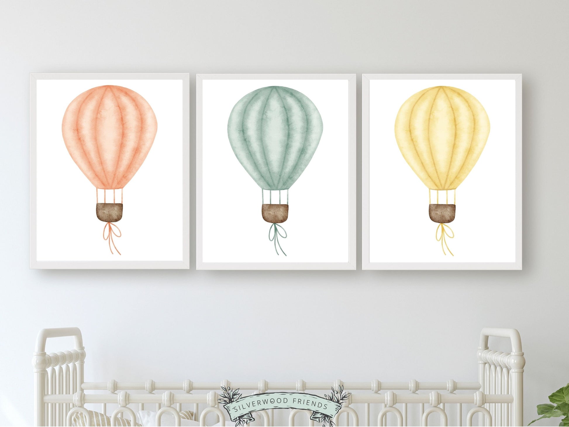 Set of 3 Hot Air Balloon Nursery Prints. Featuring charming watercolour balloons in blue, pink, and yellow, this delightful artwork creates a calm and cozy atmosphere, making it an ideal addition to your little ones space or a perfect baby shower gift.